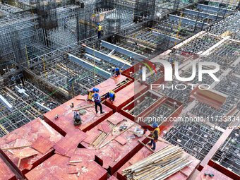 Workers work at the construction site of the Sichuan Can Invest Bazhong (Tongjiang) gas-fired power generation project in Jintang Industrial...