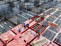 Workers work at the construction site of the Sichuan Can Invest Bazhong (Tongjiang) gas-fired power generation project in Jintang Industrial...