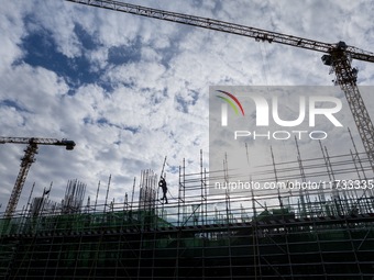 Workers work at the construction site of the Sichuan Can Invest Bazhong (Tongjiang) gas-fired power generation project in Jintang Industrial...