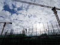 Workers work at the construction site of the Sichuan Can Invest Bazhong (Tongjiang) gas-fired power generation project in Jintang Industrial...