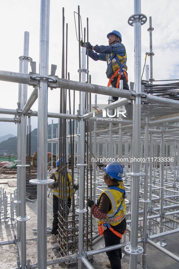 Workers work at the construction site of the Sichuan Can Invest Bazhong (Tongjiang) gas-fired power generation project in Jintang Industrial...