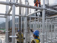 Workers work at the construction site of the Sichuan Can Invest Bazhong (Tongjiang) gas-fired power generation project in Jintang Industrial...