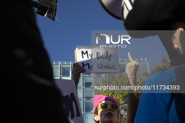 An abortion rights activist displays a sign during the National Women's March at Freedom Plaza in Washington DC, USA, on November 2, 2024. J...