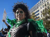 A person poses for photographs during the National Women's March at Freedom Plaza in Washington DC, USA, on November 2, 2024. Just days befo...