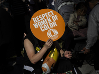 A person holds a sign during the National Women's March at Freedom Plaza in Washington DC, USA, on November 2, 2024. Just days before the US...