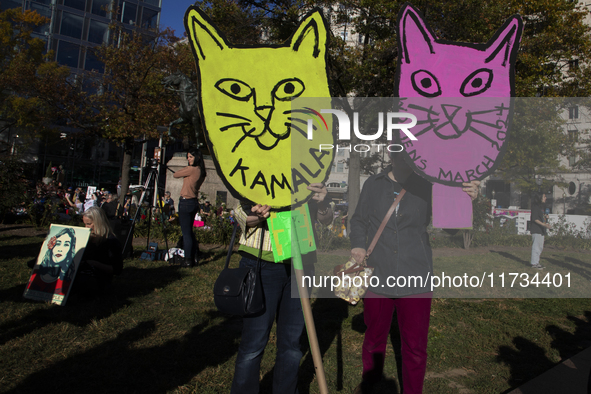 People hold signs during the National Women's March at Freedom Plaza in Washington DC, USA, on November 2, 2024. Just days before the US Ele...