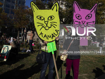 People hold signs during the National Women's March at Freedom Plaza in Washington DC, USA, on November 2, 2024. Just days before the US Ele...