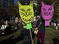 People hold signs during the National Women's March at Freedom Plaza in Washington DC, USA, on November 2, 2024. Just days before the US Ele...