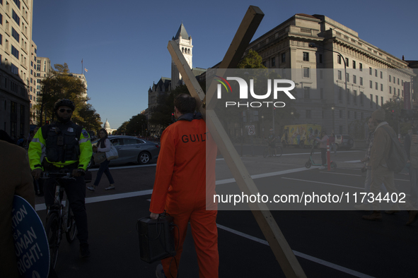 An anti-abortion rights activist carries a cross during the National Women's March in Washington DC, USA, on November 2, 2024. Just days bef...