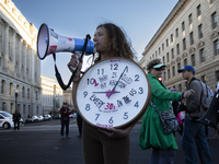 An anti-abortion rights activist holds a watch with some text during the National Women's March in Washington DC, USA, on November 2, 2024....