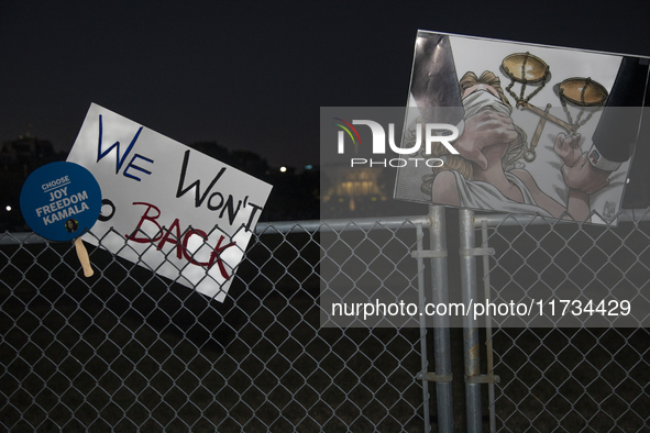 Several signs with text are displayed on the security fence of the White House during the National Women's March in Washington DC, USA, on N...