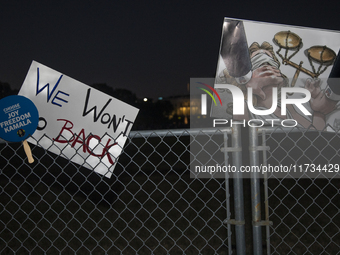 Several signs with text are displayed on the security fence of the White House during the National Women's March in Washington DC, USA, on N...