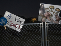 Several signs with text are displayed on the security fence of the White House during the National Women's March in Washington DC, USA, on N...