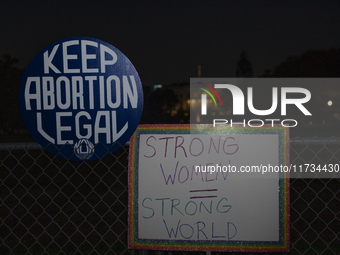 Several signs with text are displayed on the security fence of the White House during the National Women's March in Washington DC, USA, on N...