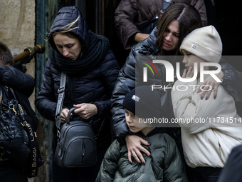 Relatives, friends, and comrades attend a funeral ceremony for Vasyl Mykytyshyn and Yuriy Pronyuk, who are killed at the front defending Ukr...