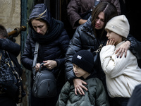 Relatives, friends, and comrades attend a funeral ceremony for Vasyl Mykytyshyn and Yuriy Pronyuk, who are killed at the front defending Ukr...