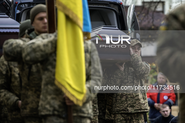 Relatives, friends, and comrades attend a funeral ceremony for Vasyl Mykytyshyn and Yuriy Pronyuk, who are killed at the front defending Ukr...