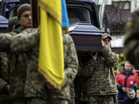 Relatives, friends, and comrades attend a funeral ceremony for Vasyl Mykytyshyn and Yuriy Pronyuk, who are killed at the front defending Ukr...