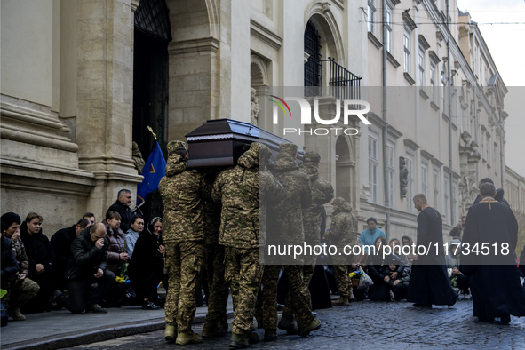 Relatives, friends, and comrades attend a funeral ceremony for Vasyl Mykytyshyn and Yuriy Pronyuk, who are killed at the front defending Ukr...