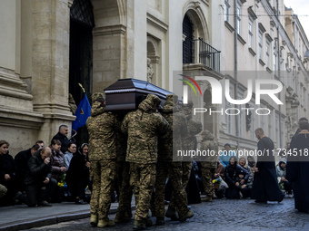 Relatives, friends, and comrades attend a funeral ceremony for Vasyl Mykytyshyn and Yuriy Pronyuk, who are killed at the front defending Ukr...