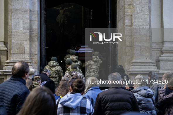 Relatives, friends, and comrades attend a funeral ceremony for Vasyl Mykytyshyn and Yuriy Pronyuk, who are killed at the front defending Ukr...