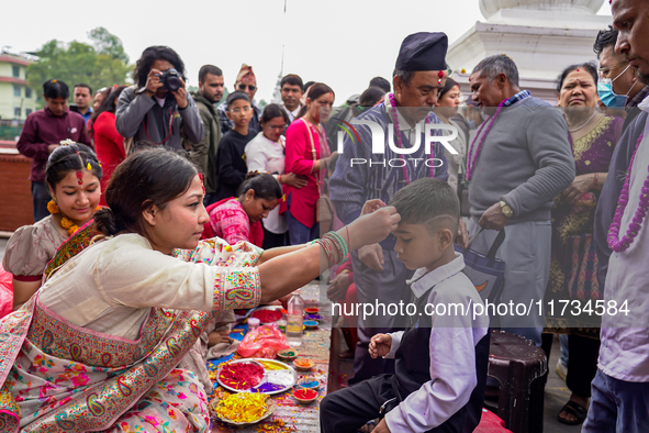 A sister applies tika on her brother's forehead, symbolizing protection and blessings, on the occasion of Bhaitika at Balgopaleshwar Temple...