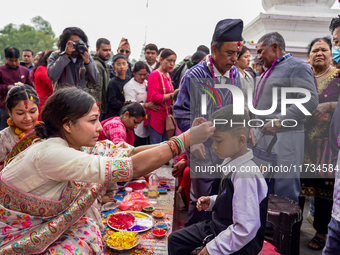 A sister applies tika on her brother's forehead, symbolizing protection and blessings, on the occasion of Bhaitika at Balgopaleshwar Temple...