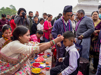 A sister applies tika on her brother's forehead, symbolizing protection and blessings, on the occasion of Bhaitika at Balgopaleshwar Temple...