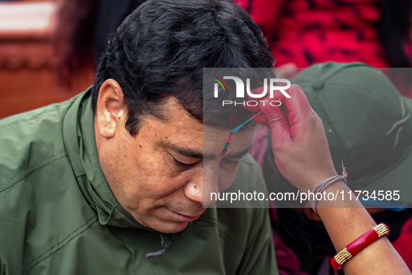 A sister applies tika on her brother's forehead, symbolizing protection and blessings, on the occasion of Bhaitika in Kathmandu, Nepal, on N...