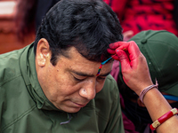 A sister applies tika on her brother's forehead, symbolizing protection and blessings, on the occasion of Bhaitika in Kathmandu, Nepal, on N...