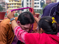 A sister applies tika on her brother's forehead, symbolizing protection and blessings, on the occasion of Bhaitika in Kathmandu, Nepal, on N...