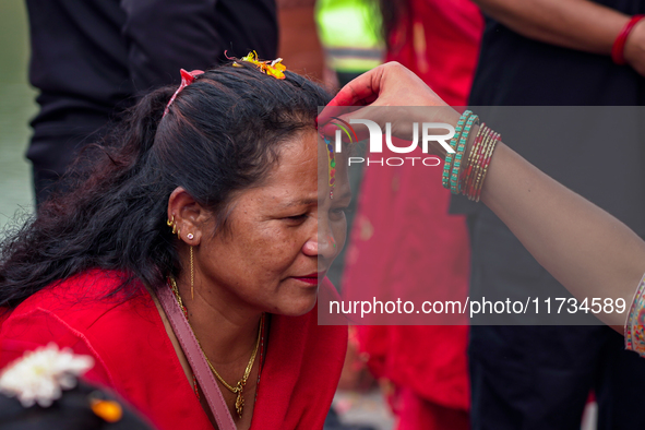 A sister applies tika on her sister's forehead, symbolizing protection and blessings, on the occasion of Bhaitika in Kathmandu, Nepal, on No...