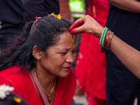 A sister applies tika on her sister's forehead, symbolizing protection and blessings, on the occasion of Bhaitika in Kathmandu, Nepal, on No...