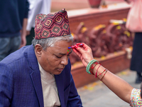 A sister applies tika on her brother's forehead, symbolizing protection and blessings, on the occasion of Bhaitika at Balgopaleshwar Temple...