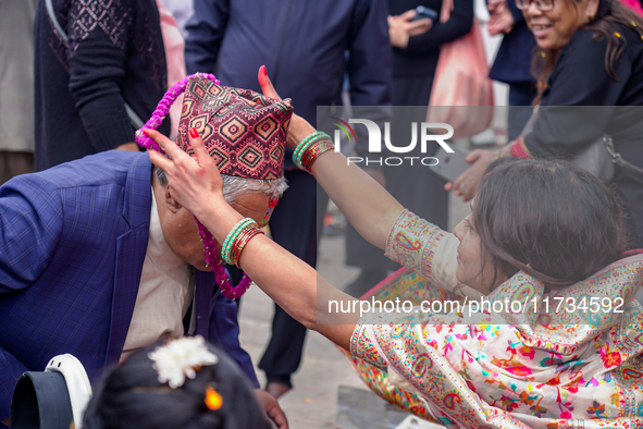 A sister applies tika on her brother's forehead, symbolizing protection and blessings, on the occasion of Bhaitika at Balgopaleshwar Temple...