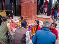 A sister applies tika on her brother's forehead, symbolizing protection and blessings, on the occasion of Bhaitika in Kathmandu, Nepal, on N...