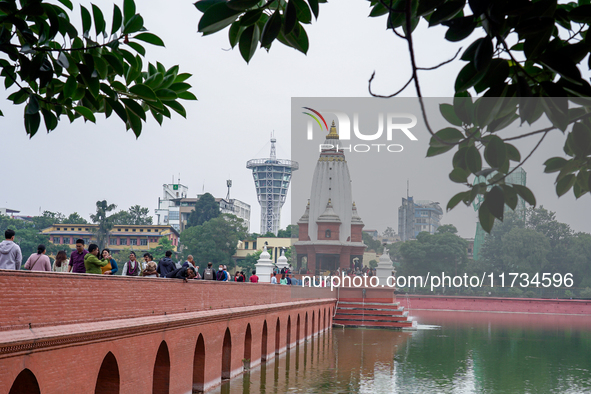 People walk to participate in the Bhaitika pooja at Balgopaleshwar Temple in Kathmandu, Nepal, on November 3, 2024. 