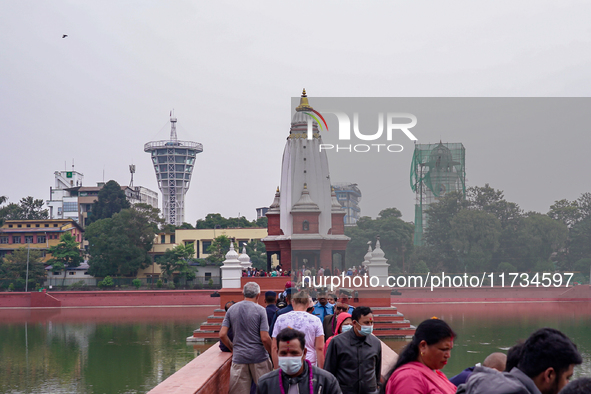 People walk to participate in the Bhaitika pooja at Balgopaleshwar Temple in Kathmandu, Nepal, on November 3, 2024. 