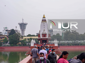 People walk to participate in the Bhaitika pooja at Balgopaleshwar Temple in Kathmandu, Nepal, on November 3, 2024. (