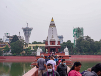 People walk to participate in the Bhaitika pooja at Balgopaleshwar Temple in Kathmandu, Nepal, on November 3, 2024. (