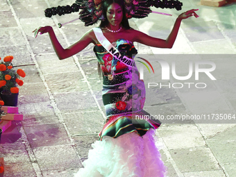 Miss Namibia Prisca Anyolo walks on the runway during the Miss Universe Catrinas Gala at Antiguo Colegio de las Vizcainas in Mexico City, Me...