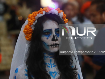 A person takes part in the Annual Day of the Dead Catrinas Parade at the Sanctuary of Guadalupe as part of Mexican Dia de Muertos celebratio...