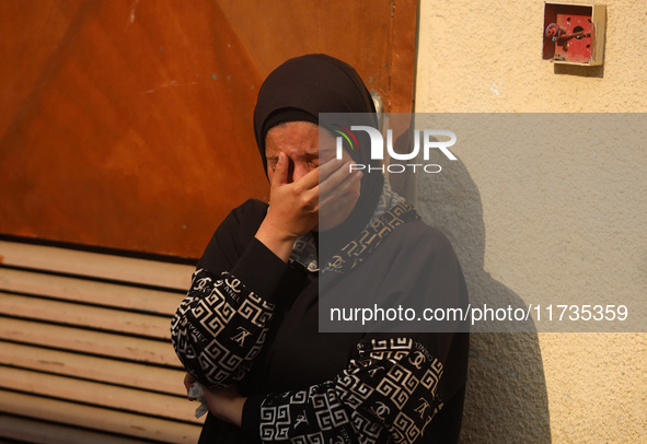 Mourners weep near the bodies of Palestinians killed in an Israeli airstrike amid the conflict between Israel and Hamas in Deir al-Balah, ce...