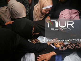 Mourners gather around the bodies of Palestinians killed in an Israeli strike amid the Israel-Hamas conflict in Deir Al-Balah, in the centra...