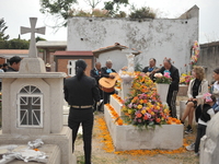 People decorate the graves of their loved ones with cempasuchil flowers at the Municipal Cemetery of San Juan del Rio. Mexicans visit the ce...