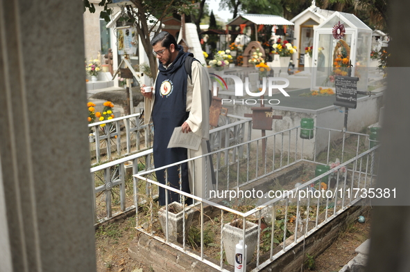 A person decorates the grave of their loved ones with cempasuchil flowers at the Municipal Cemetery of San Juan del Rio. Mexicans visit the...