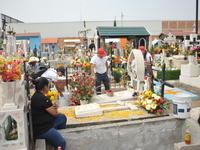 People decorate the graves of their loved ones with cempasuchil flowers at the Municipal Cemetery of San Juan del Rio. Mexicans visit the ce...