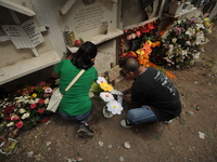 People decorate the graves of their loved ones with cempasuchil flowers at the Municipal Cemetery of San Juan del Rio. Mexicans visit the ce...