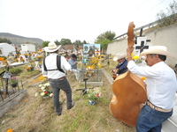 People decorate the graves of their loved ones with cempasuchil flowers at the Municipal Cemetery of San Juan del Rio. Mexicans visit the ce...