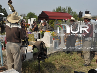 People decorate the graves of their loved ones with cempasuchil flowers at the Municipal Cemetery of San Juan del Rio. Mexicans visit the ce...